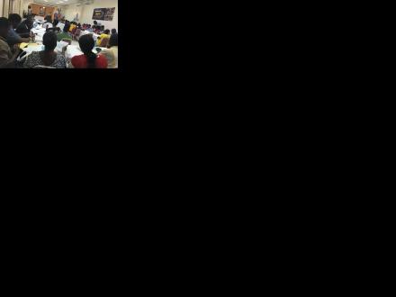 A room of people sitting at desks